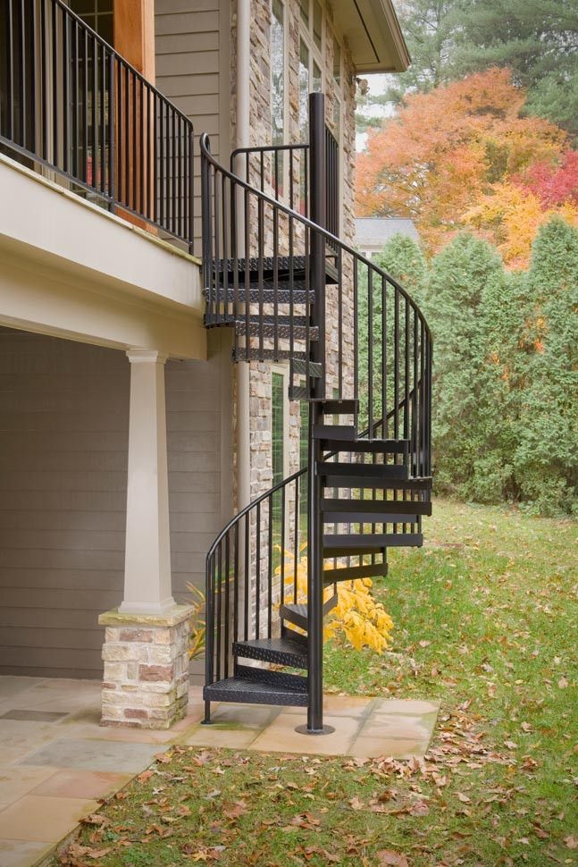 Metal spiral staircase at side of house.