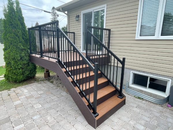 Small deck with railing and stairs.